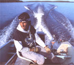 Guide George Merasty has put the outboard at full throttle. Since Nueltin Lake is more than 120 miles long, getting to a good fishing site from any of the three camps will typically involve traveling 30 or 40 miles one way. That means motoring along at a good clip.